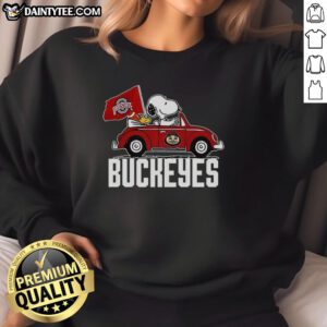 Alt Text: Premium Snoopy and Woodstock driving a car with Ohio State Buckeyes flag on a cozy sweatshirt design.