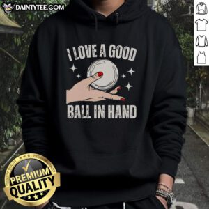 Girl wearing 'I Love A Good Ball In Hand' hoodie, showcasing a confident pose with a ball in hand, stylish and fun.