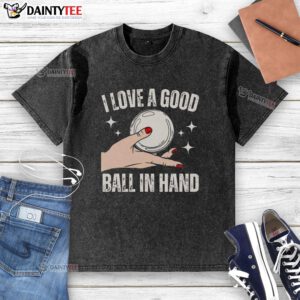 Girl holding a ball, wearing an 'I Love a Good Ball' hand-washed t-shirt, showcasing playful style and sports enthusiasm.