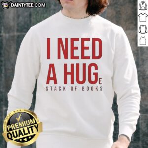 Cozy 'Awesome I Need A Huge Stack Of Books' sweatshirt displayed on a wooden table with scattered books around it.