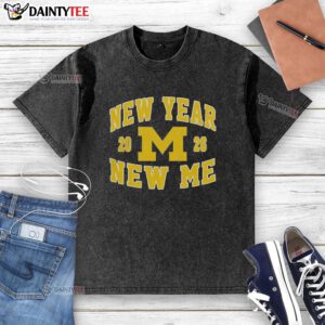Alt Text: Awesome Michigan Wolverines Football New Year New Me 2026 logo on a washed t-shirt, perfect for fans.