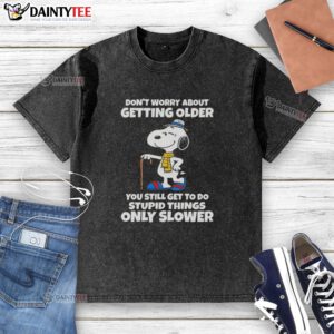Cute Snoopy graphic on a washed t-shirt with a humorous quote about aging and doing silly things, perfect for casual wear.