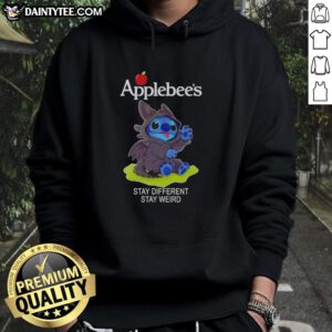 Adorable Stitch cosplay wearing a Toothless X Applebee's hoodie with 'Stay Different, Stay Weird' slogan.