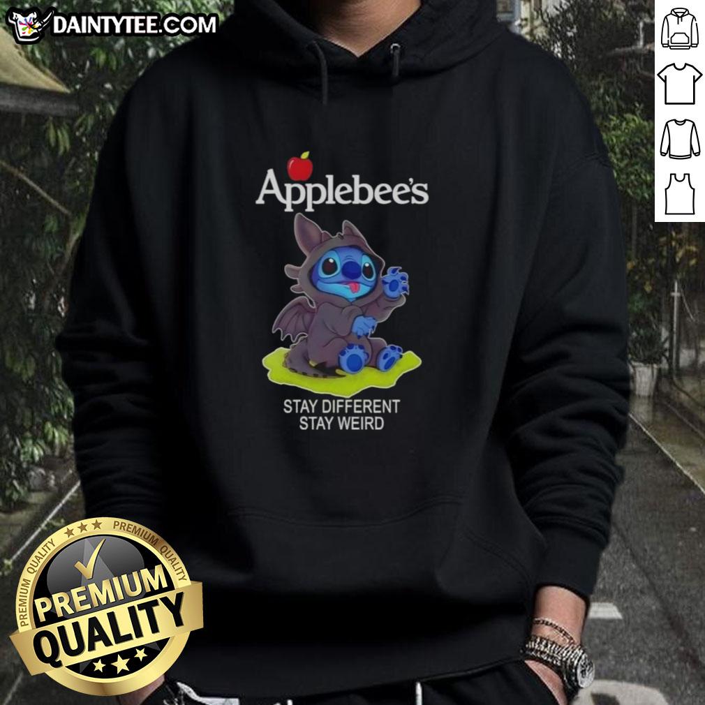 Adorable Stitch cosplay wearing a Toothless X Applebee's hoodie with 'Stay Different, Stay Weird' slogan.