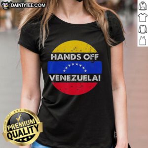 Retro ladies tee featuring 'Good I Stand With Hands Off Venezuela' design and flag circle, promoting solidarity and awareness.