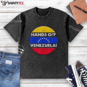 Retro washed t-shirt featuring 'Good I Stand With Hands Off Venezuela' design and flag in a circular graphic.