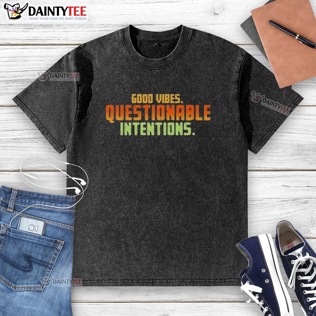 Alt Text: Trendy Good Vibes Questionable Intentions washed t-shirt displayed on a wooden background, perfect for casual outfits.