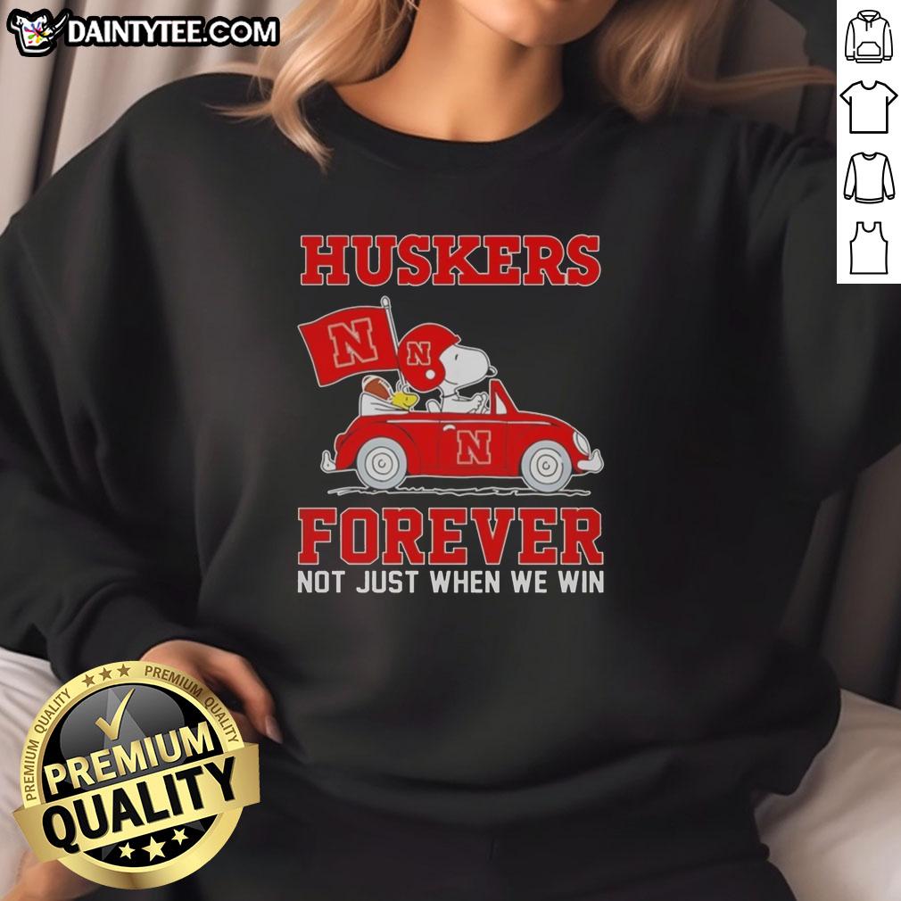 Alt Text: Hot Snoopy and Woodstock driving a car while wearing Nebraska Huskers sweatshirt, showcasing fun team spirit.