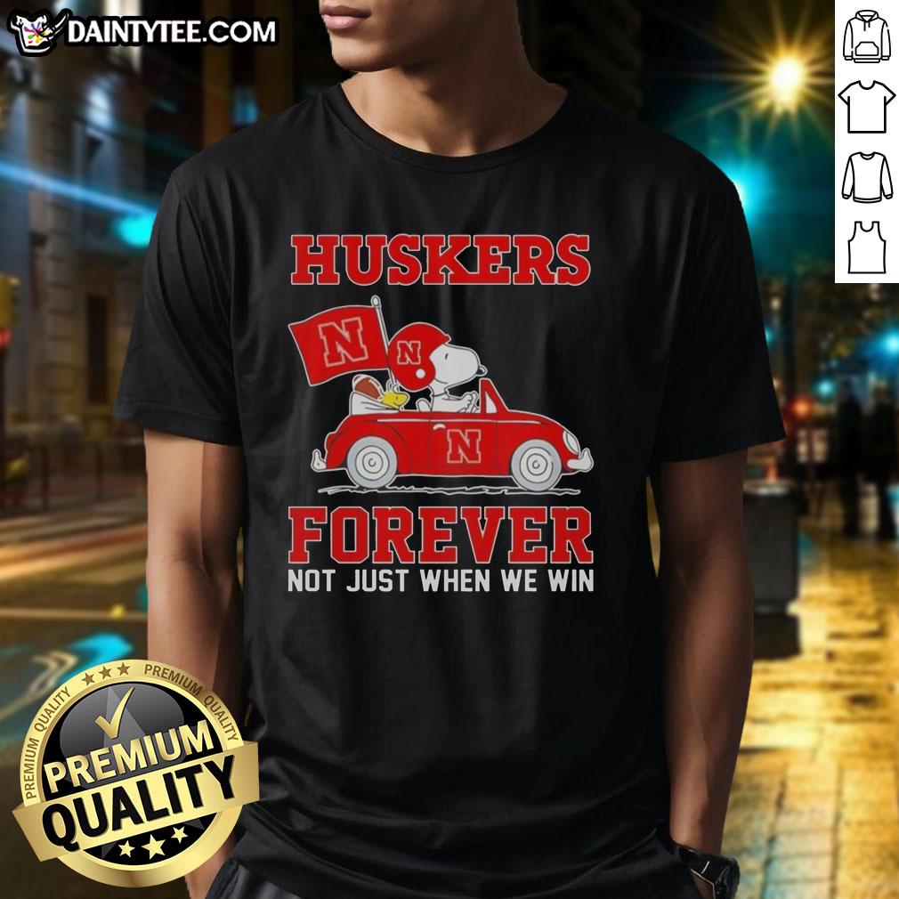 Hot Snoopy and Woodstock driving a car on a Nebraska Huskers T-shirt, perfect for fans of both Peanuts and college sports.