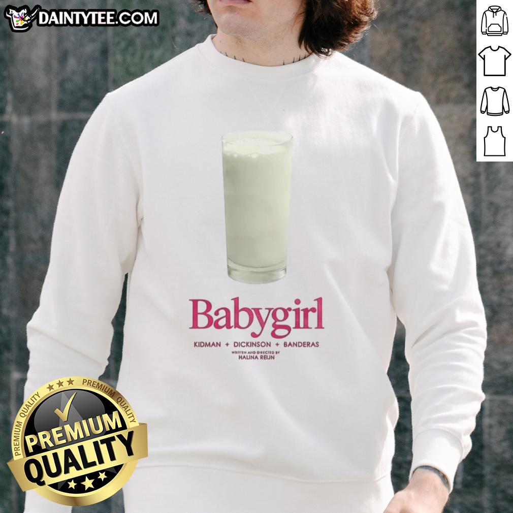 Adorable baby girl wearing a Nice sweatshirt featuring Kidman, Dickinson, and Banderas designs, smiling happily.