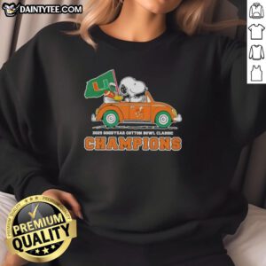 Alt Text: Premium 2025 Goodyear Cotton Bowl Classic Champions sweatshirt featuring Snoopy driving a car for Miami Hurricanes football.