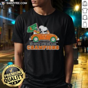 Alt Text: Premium 2025 Goodyear Cotton Bowl Classic Champions T-Shirt featuring Snoopy driving a car for Miami Hurricanes football.