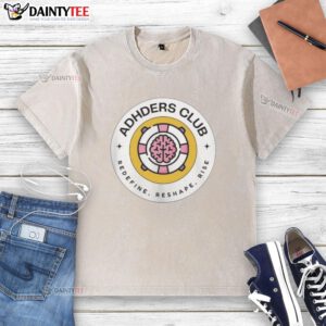 Alt Text: Top Adhders Club Redefine Reshape Rise logo on a washed t-shirt, showcasing a stylish and motivational design.