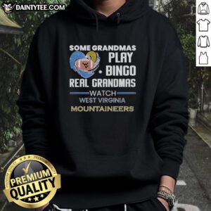 Grandmas enjoying bingo while wearing West Virginia Mountaineers hoodies, showcasing fun and team spirit.