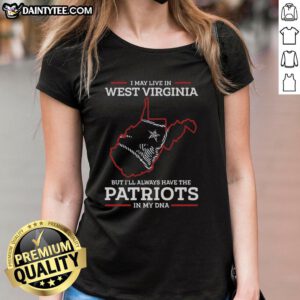 Lady wearing 'I May Live In West Virginia But Ill Always Have The New England Patriots In My DNA' tee, showcasing team pride.