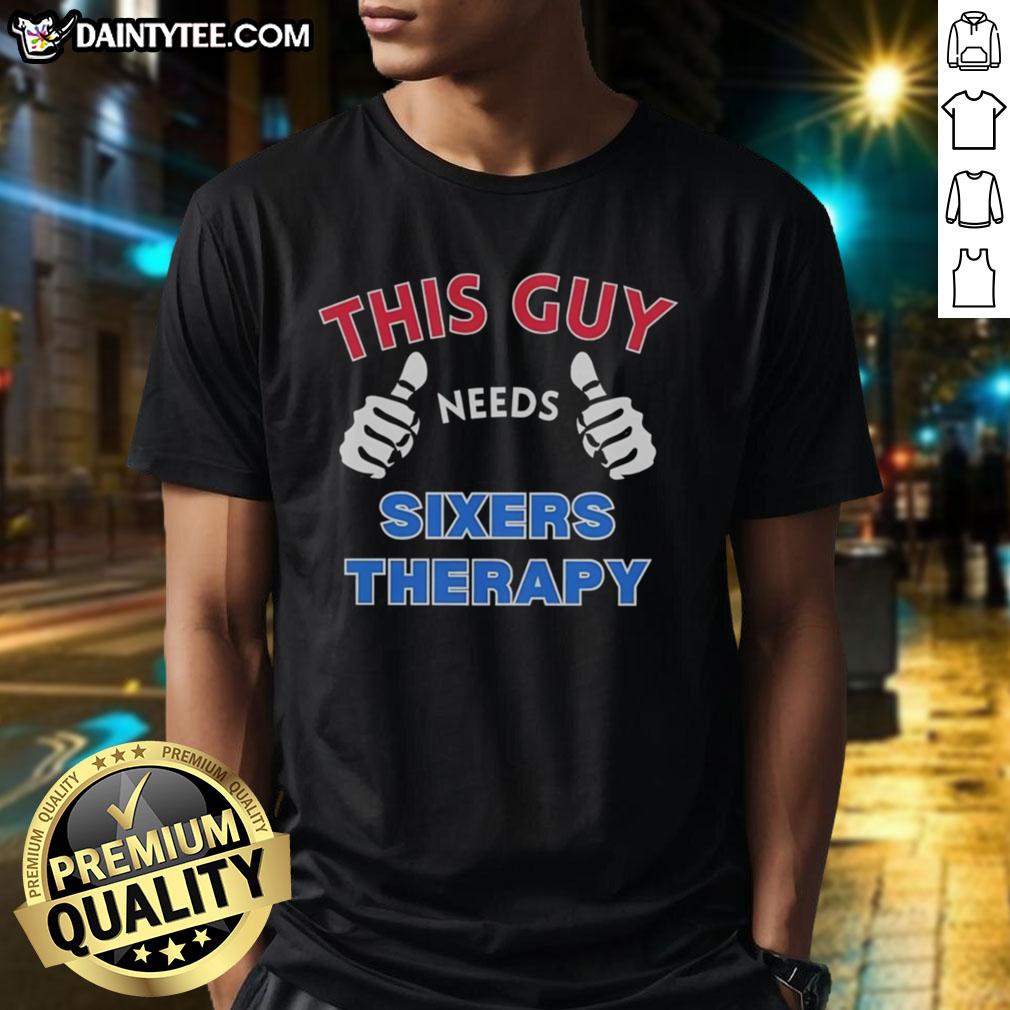 Alt Text: Awesome Philadelphia 76ers 'This Guy Needs Sixers Therapy' T-Shirt featuring bold graphics and team colors.