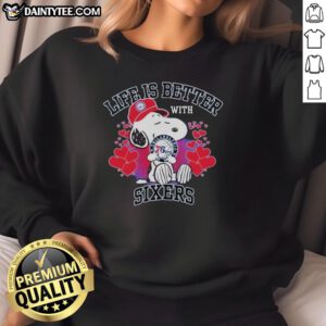 Snoopy wearing a Philadelphia 76ers logo sweatshirt with 'Life Is Better With Sixers' slogan, perfect for fans.
