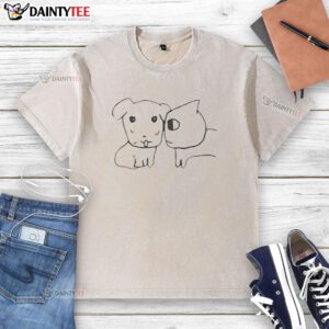 Cute dog and cat best friends wearing a washed t-shirt, showcasing their adorable bond in a cozy setting.