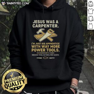 Man wearing 'Nice Jesus Was A Carpenter' hoodie with tools, showcasing the fun design for carpenters and DIY enthusiasts.