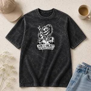 Pretty Skeleton Girl Saying Am I Okay We Both Laughed design on a soft washed t shirt in light grey