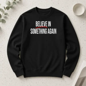 Top Believe In Something Again long sleeve shirt in black, front view with printed slogan